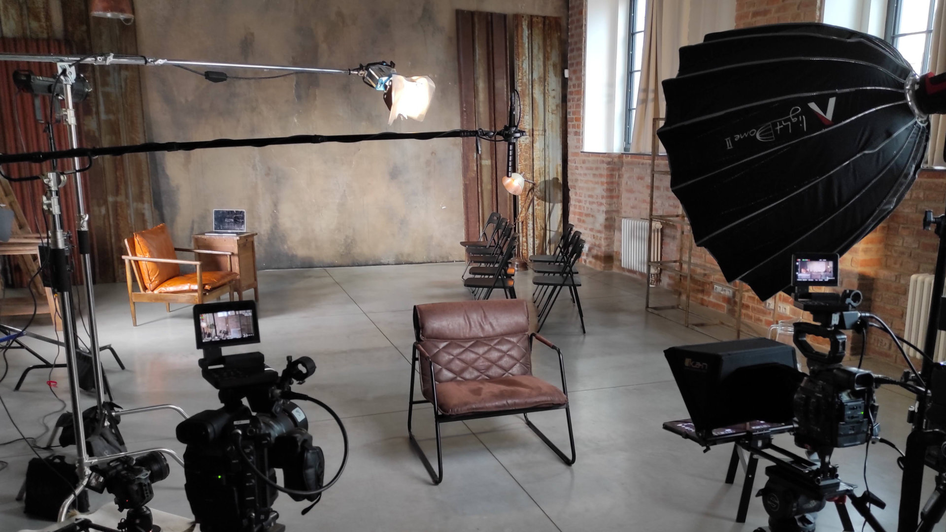 Preparing the scene and equipment for an in-studio interview shoot.